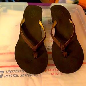 BCBG brown and gold wedge flip flops.